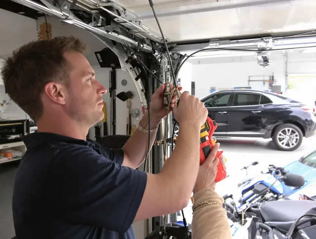 Hopkinton Garage Door Repair safety certified technician performing cable replacement in Hopkinton